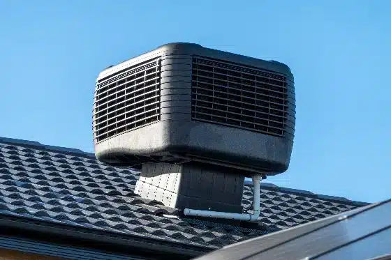 An evaporative cooler on top of a house