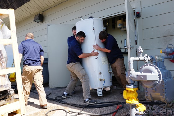 Multiple Radiant Plumbing technicians installing water heater 560x373 2