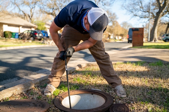 Radiant technician clearing out sewer drain 560x373 2