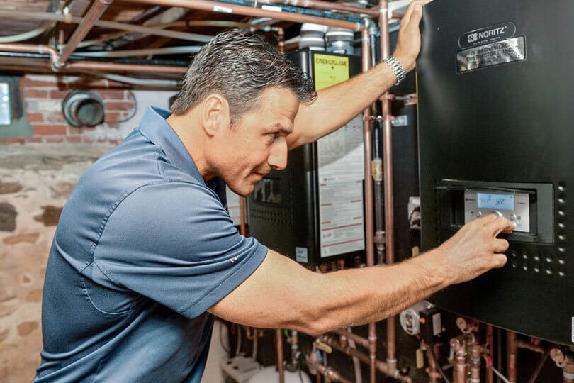 A tech working on a water heater.