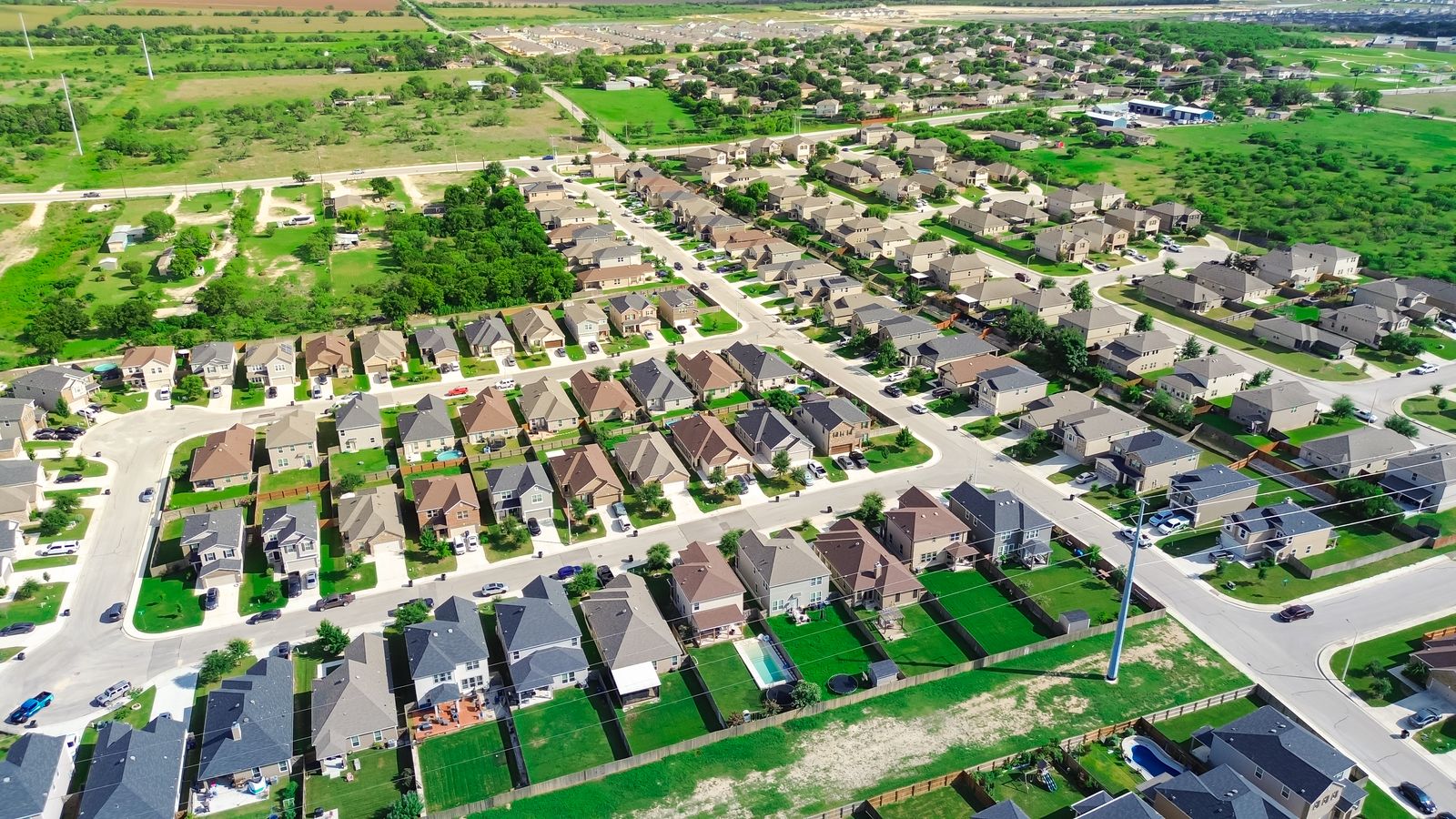 An aerial photograph of a general Central Texas neighborhood on a sunny day.