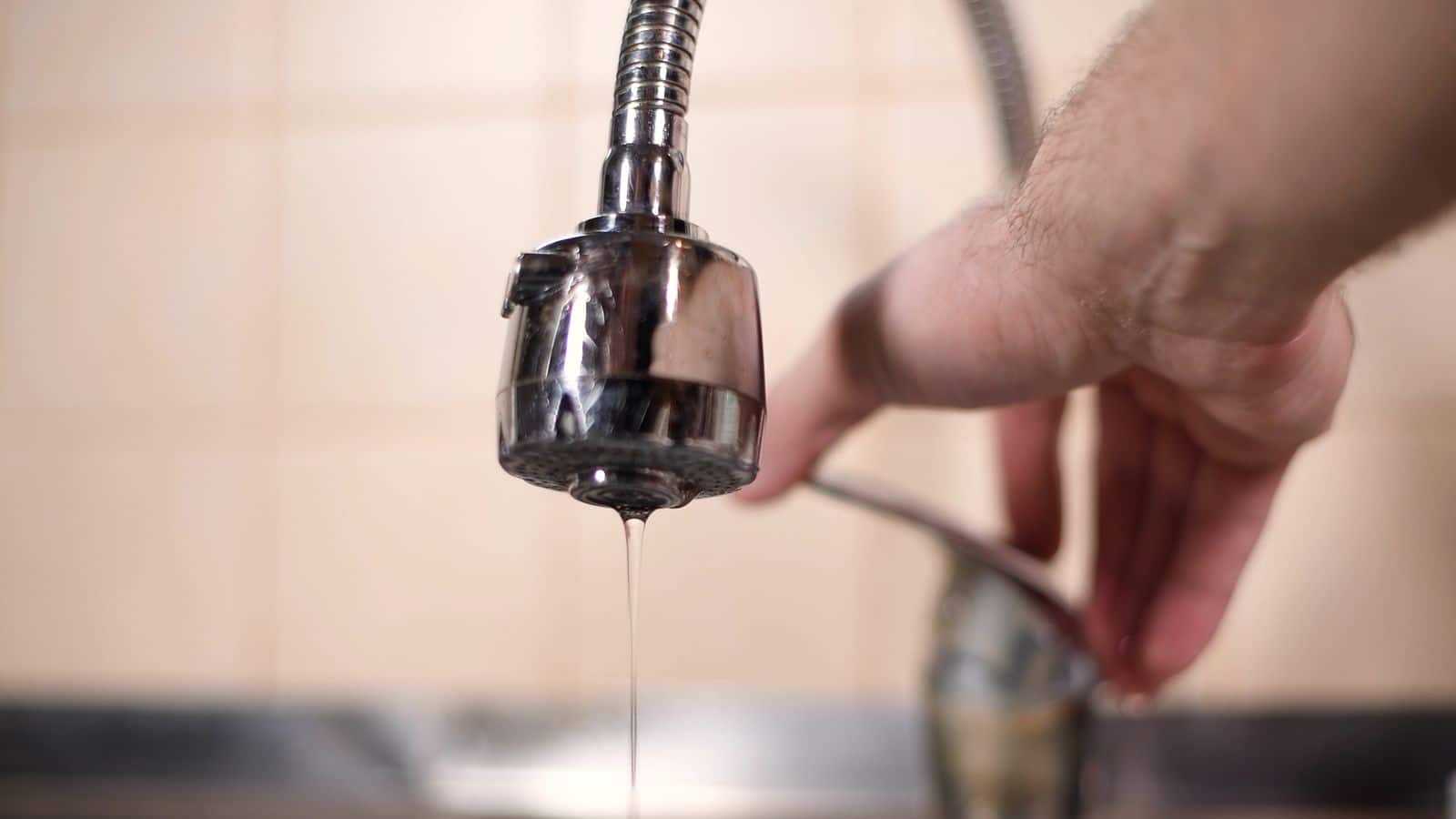 A faucet with a slow drip of water coming out