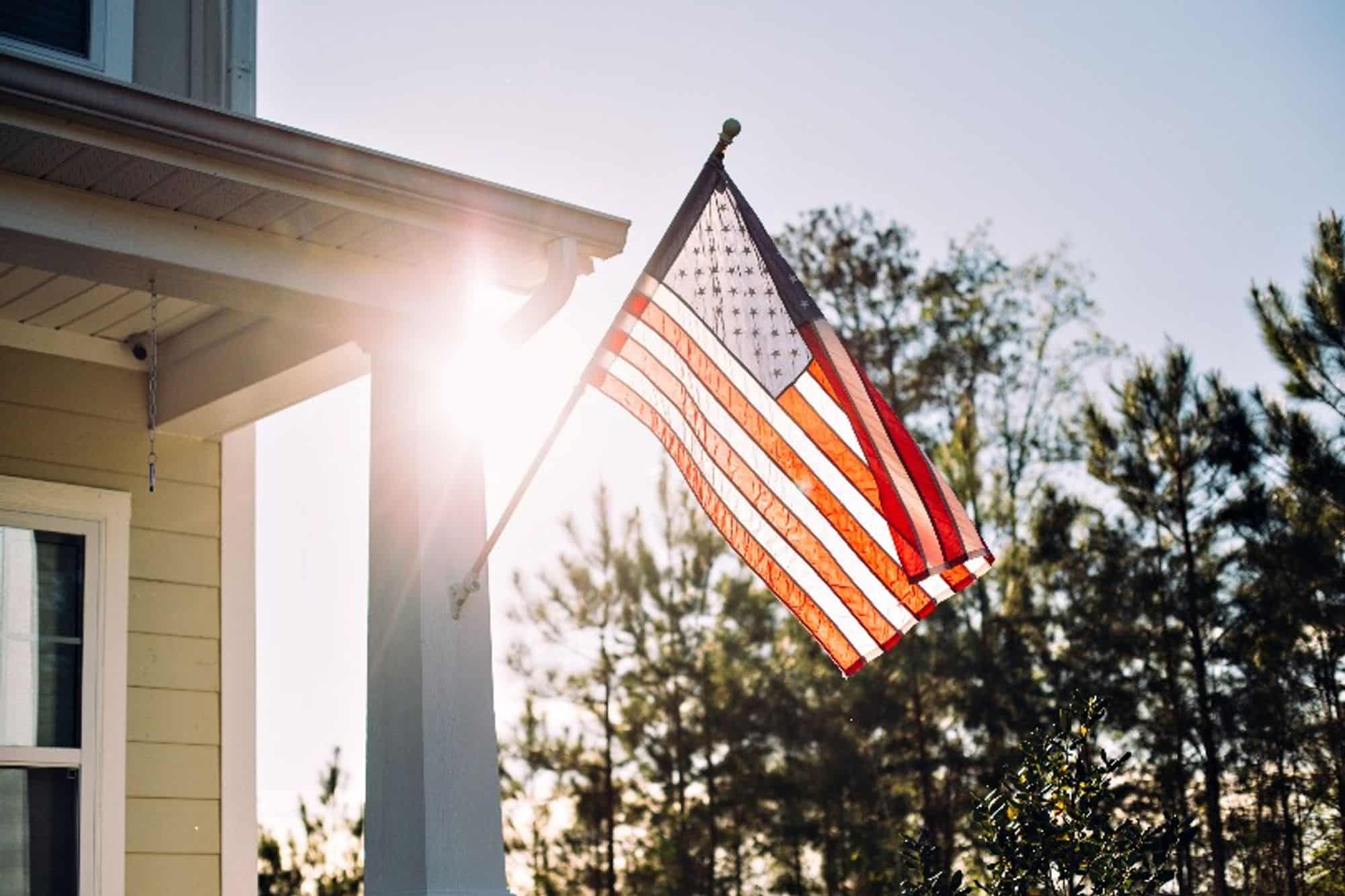 American Flag outside home at sunset