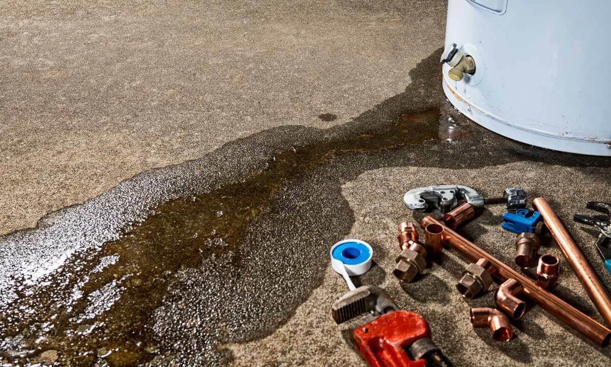 A water heater with a leak at the base